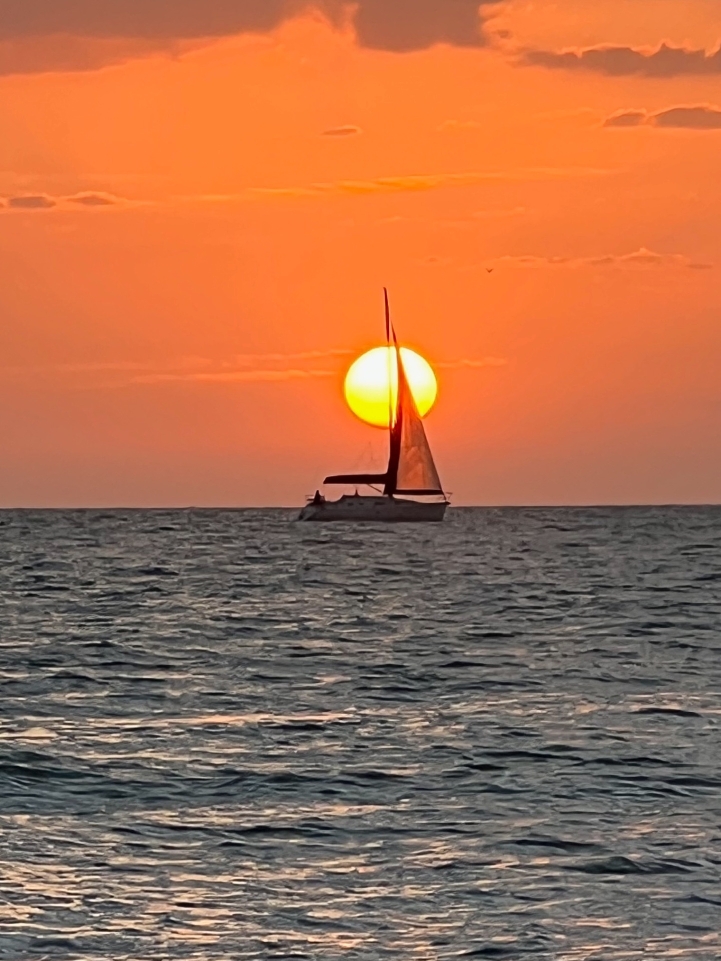 Private Beach — sailboat at sunset off Moorings Beach