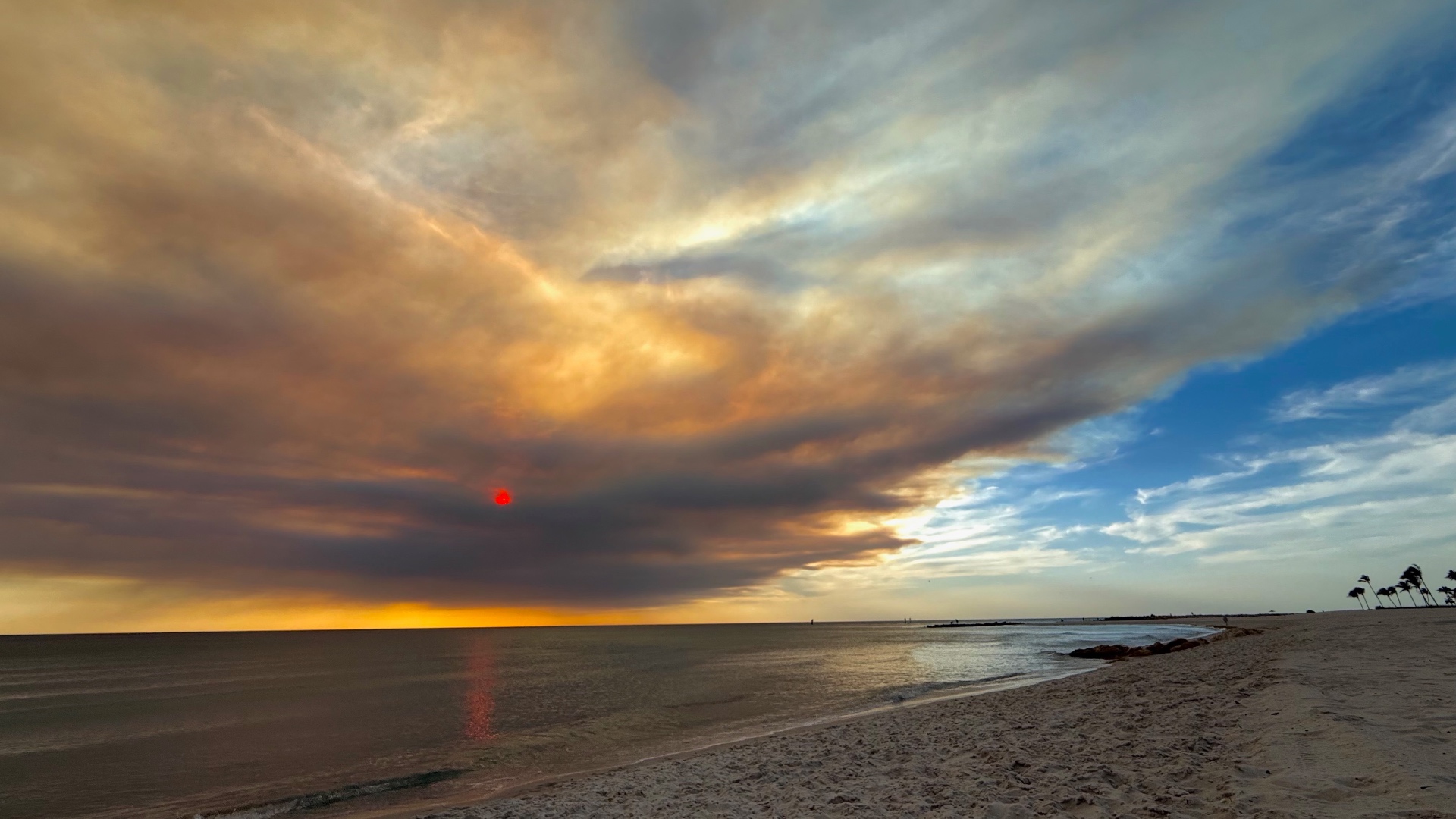 Sunset skies over the Gulf beach